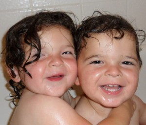 twins hugging in the bath